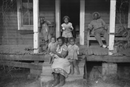 One of tenant families on their porch, Marcella Plantation, Mileston, Mississippi Delta, Mississippi