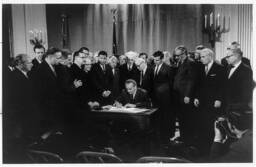 In this photograph President Lyndon B. Johnson signs the Civil Rights Act of April 11, 1968, which is also known as the Fair Housing Act. 