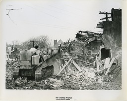 <p>This photograph, the second in a series labeled “First Buildings on Vinegar Hill Go Down” in the Rip Payne photography collection at the Albemarle Charlottesville Historical Society, shows a mostly destroyed home in Charlottesville’s Vinegar Hill neighborhood. The tower of Zion Union Baptist Church is visible in the background.</p> 