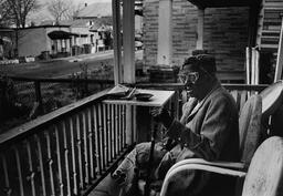 <p>Gladys C. Cooke, an 80-year-old life-long resident of the Carver neighborhood in Richmond, is shown seated on her porch in this 1990 photograph.</p>