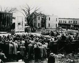 <p>Hundreds of people attend the opening ceremony for Norfolk’s first urban renewal project, held on December 11, 1951. The crowd is segregated, with Black attendees standing across the street from the main stage. A bulldozer is staged next to the first structure to be torn down.</p>