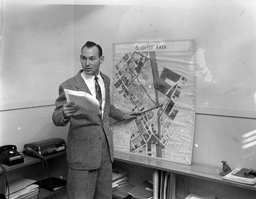 <p>In 1955, inspector J. Harold Sawyer of the Norfolk Housing and Redevelopment Authority presents a map of Norfolk’s blighted areas for the city’s second major urban renewal project, “Project Two.” </p>