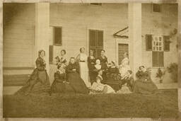 <p>The attendees of the 1870 Mount Vernon Ladies’ Association council session pose for a photograph on the east front of Mount Vernon. Anne Pamela Cunningham, the regent, sits with a wreath in her lap in a tall-backed chair, gazing in reverence at a bust of George Washington. This is the earliest known photograph of the Mount Vernon Ladies’ Association.</p> 