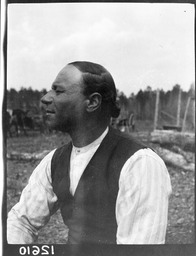 <p>Ozias Westmore Adkins, the chief of the Chickahominy tribe from 1918 to 1939, sits outside in a shirt and vest with his hair pulled back in this 1918 photograph by ethnologist Frank G. Speck. As chief, Adkins spoke out against Virginia’s 1924 Racial Integrity Law.</p> 