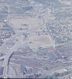 <p>This aerial photograph shows the aftermath of Roanoke’s Commonwealth Redevelopment Project, with the area between Second Street (now the I-581 Corridor) and Commonwealth Road (Now the Williamson Road Corridor) almost completely cleared of all residential housing. The Roanoke Civic Center was later constructed in what had been the heavily populated Commonwealth neighborhood.</p> 