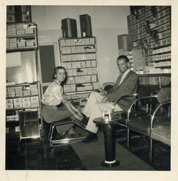 <p>A saleswoman and patron of Economy Shoe Repair, a business on Henry Street in the historically Black community of Gainsboro, in Roanoke, smile for the camera.</p> 