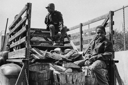 <p>Three kids mug for the camera in the bed of a truck loaded with firewood outside of Charlottesville’s Jefferson School. The Jefferson School had, until shortly before this photograph was taken, been the segregated elementary school designated for Charlottesville's Black students. At the time of this photograph Charlottesville schools were just beginning the process of integration.</p>